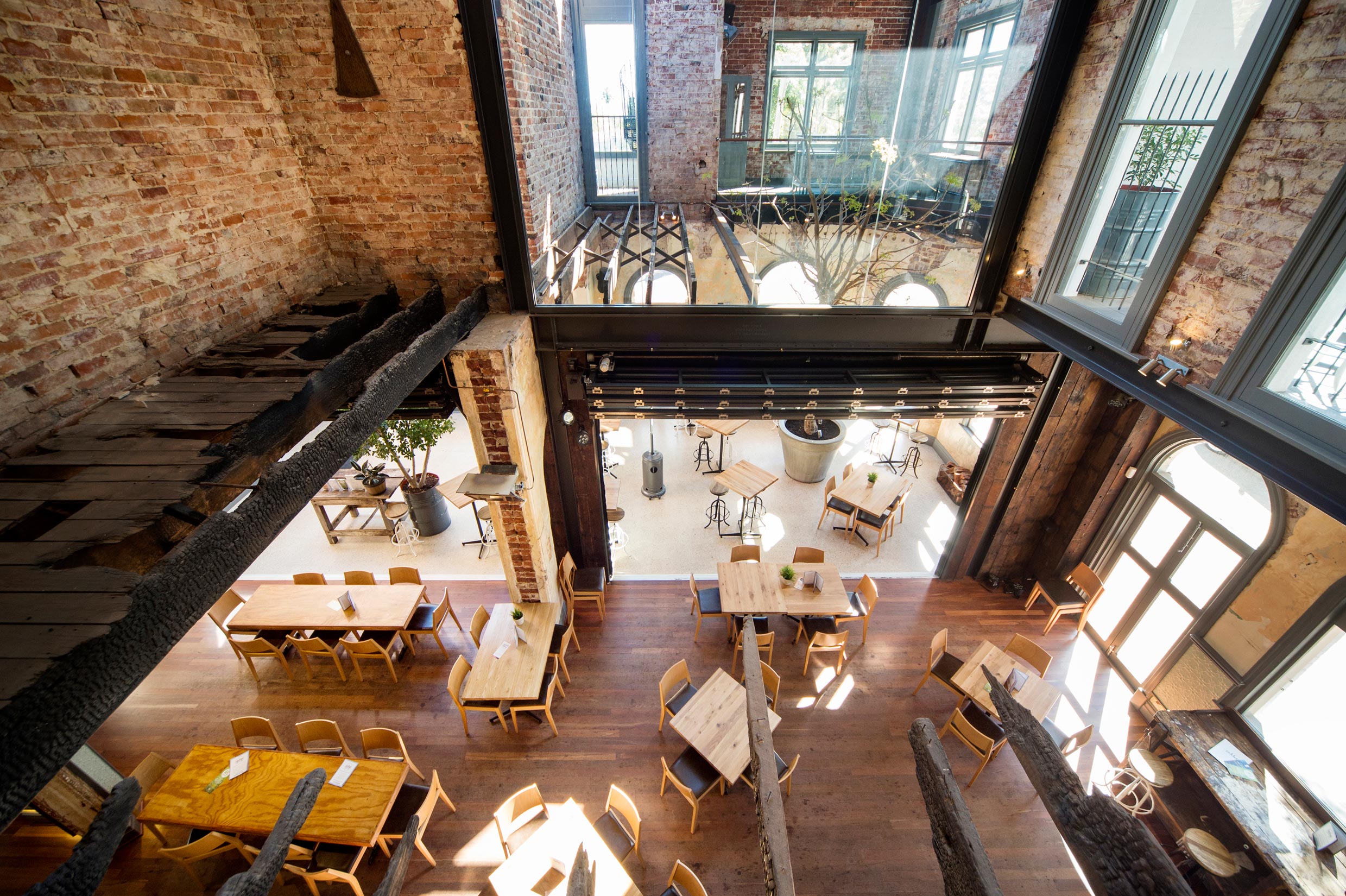 The Guildford Hotel heritage dining room with restored brick walls, steel beams and original burnt timber beams