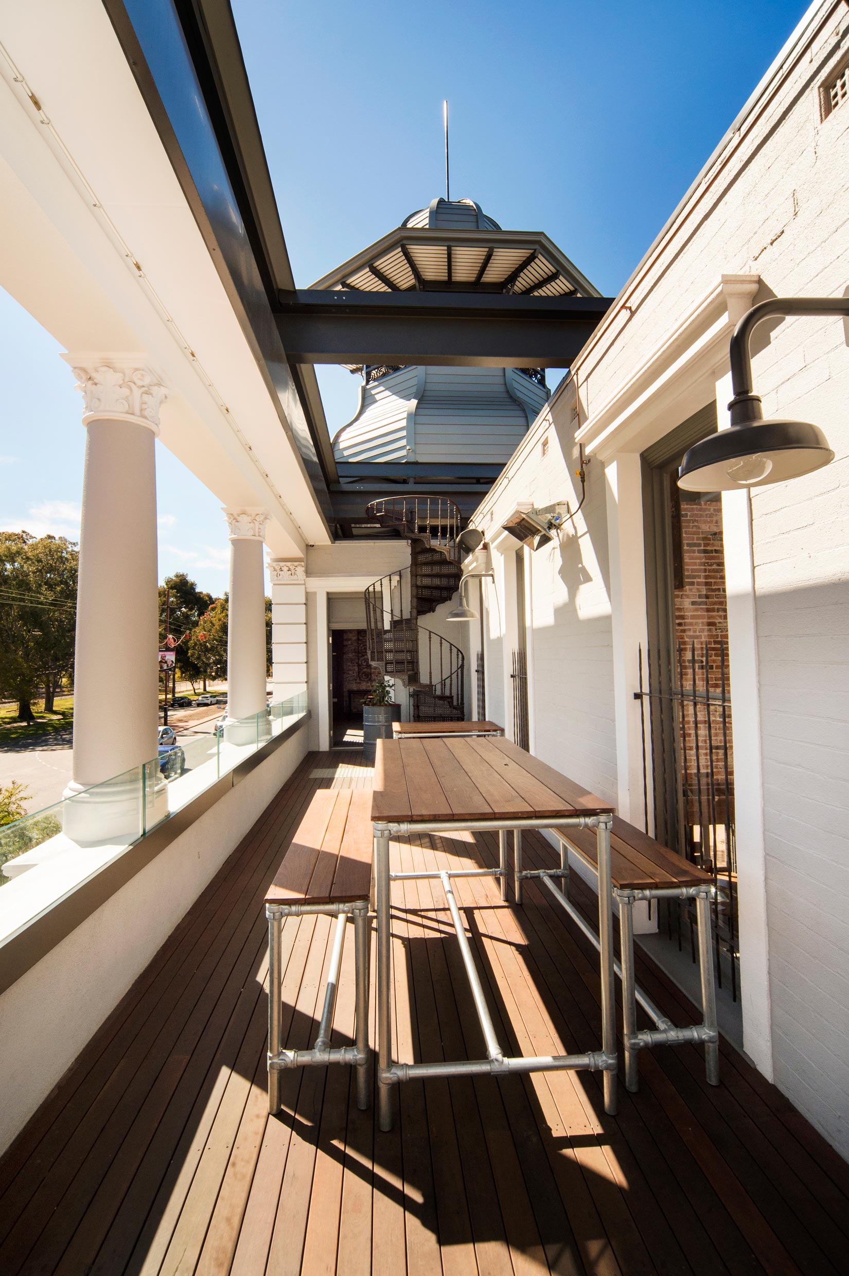 The Guildford Hotel balcony with white brickwork walls, white corinthian columns and belvedere in the background