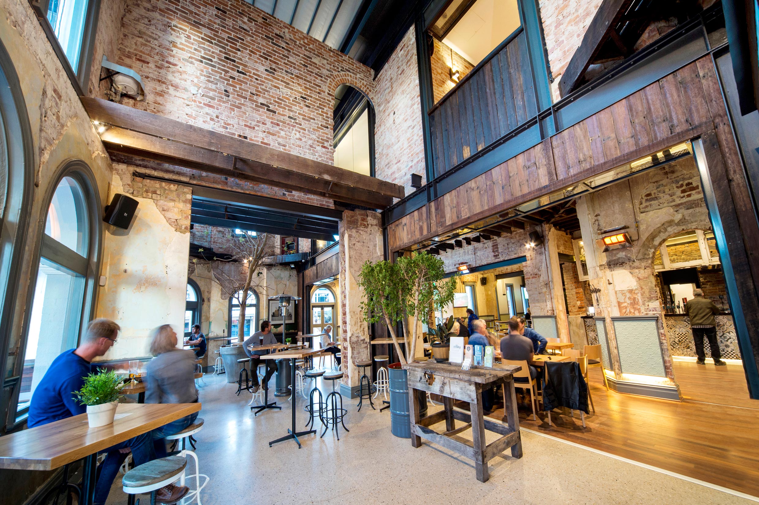 heritage dining room at the Guildford Hotel with brick walls, archways, and restored timber beams