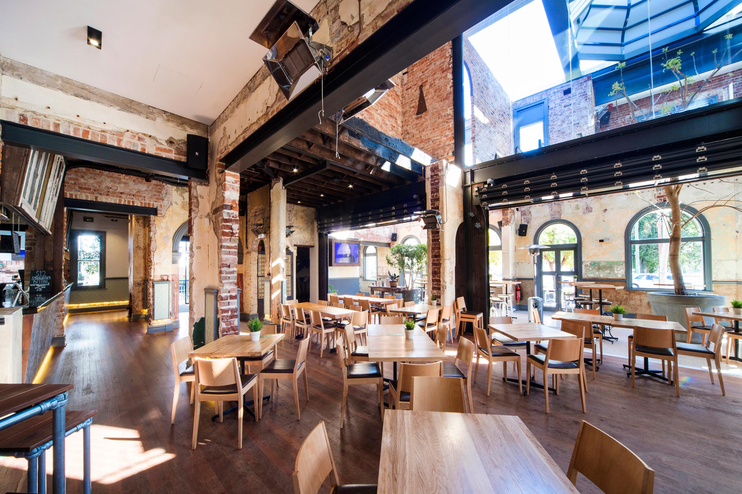 The Guildford Hotel heritage dining room with restored brick walls, steel beams and timber floors