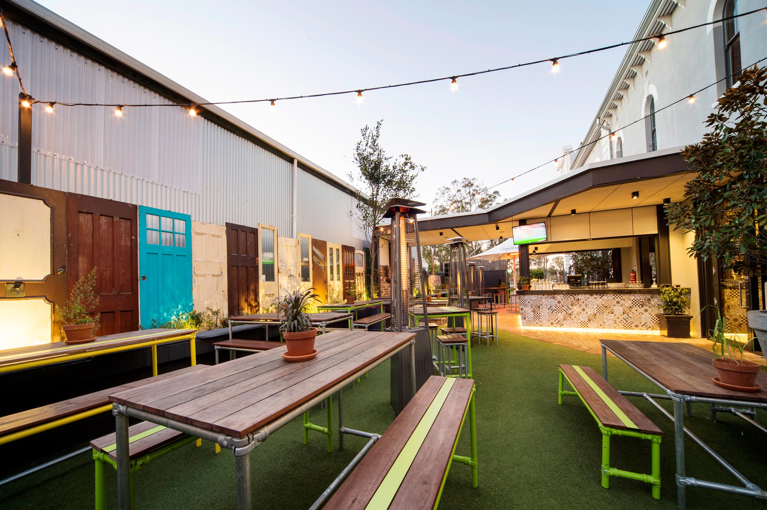 beer garden with grass and fairy lights at the Guildford Hotel