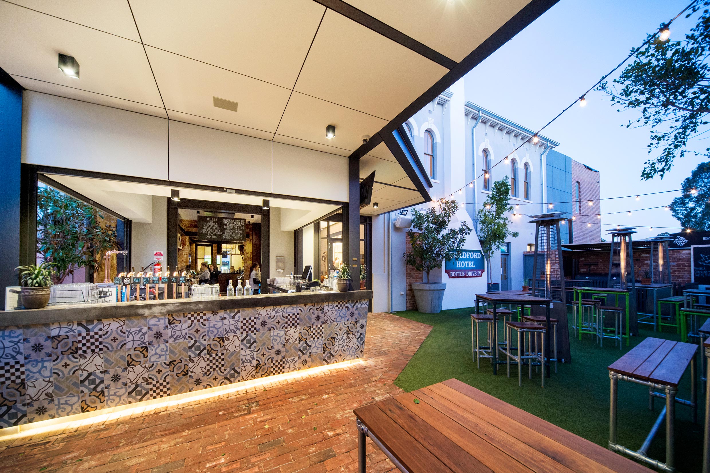 Beer garden outdoor bar with grass and fairy lights at the Guildford Hotel