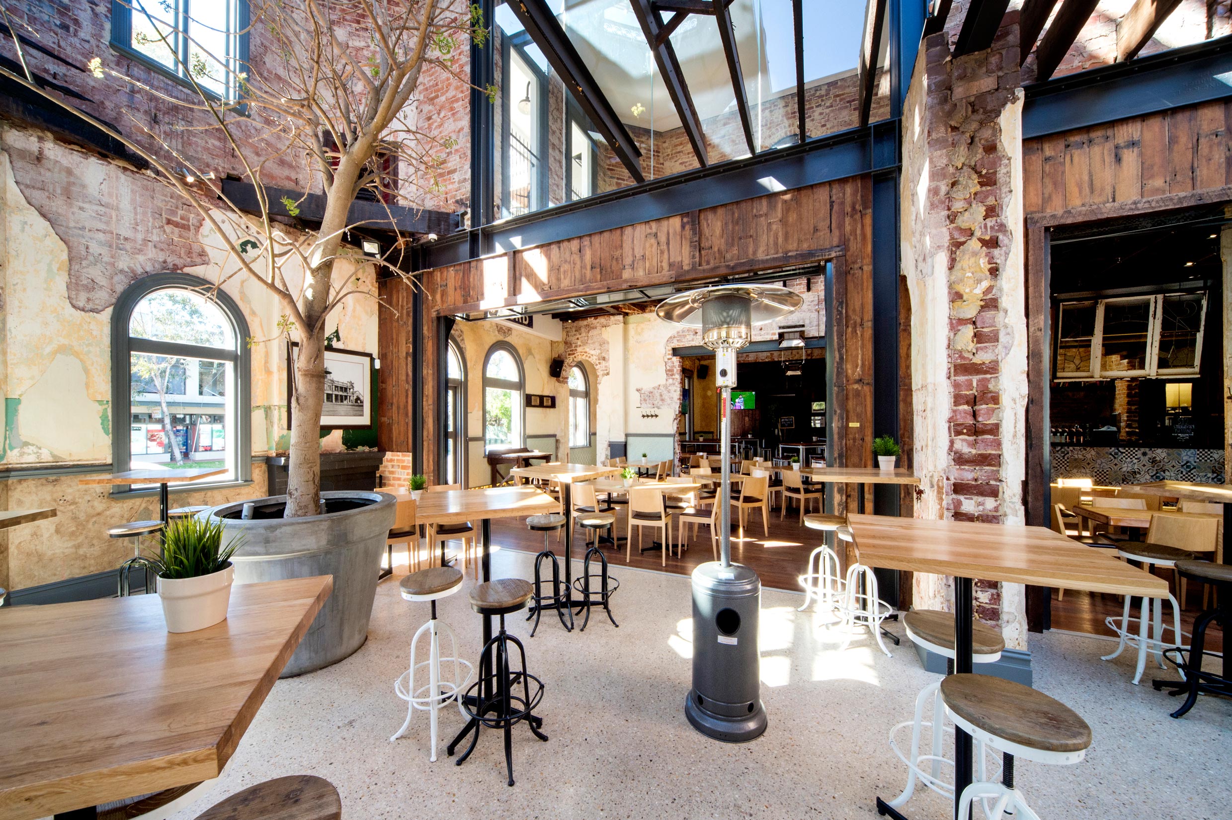 The Guildford Hotel heritage dining room with restored brick & timber walls, steel beams and concrete floors