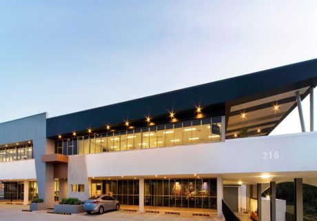 White, grey, and black office building in Balcatta with large angled cantilevered roof