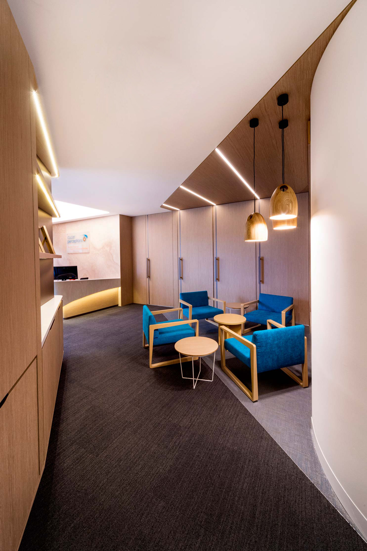 office waiting lounge with timber cabinet walls and timber doors