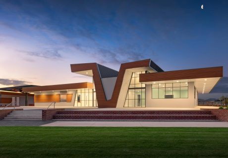 Rossiter sporting pavilion with a timber facade is lit up at night