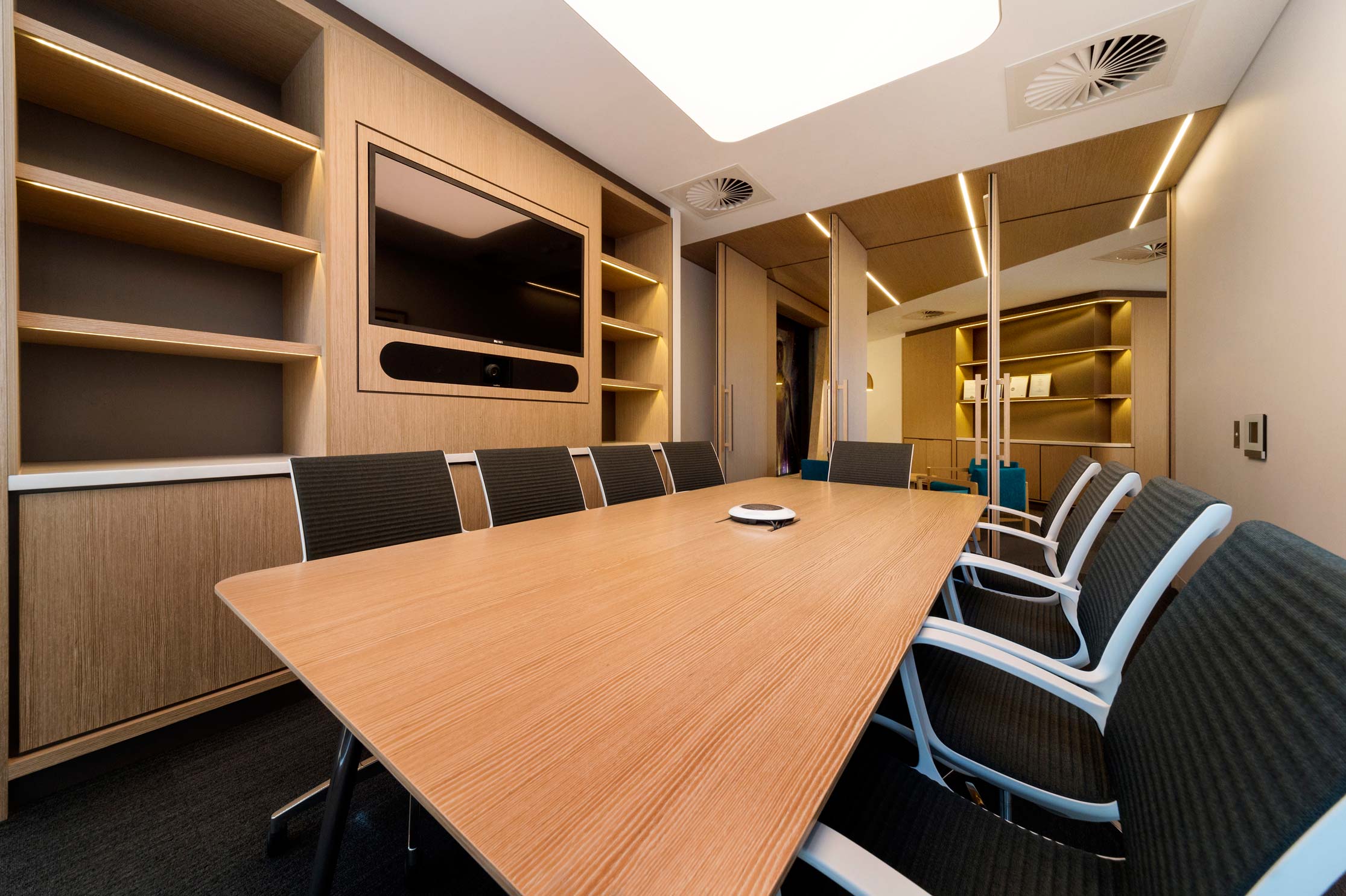 timber cladded office boardroom with pivoting doors